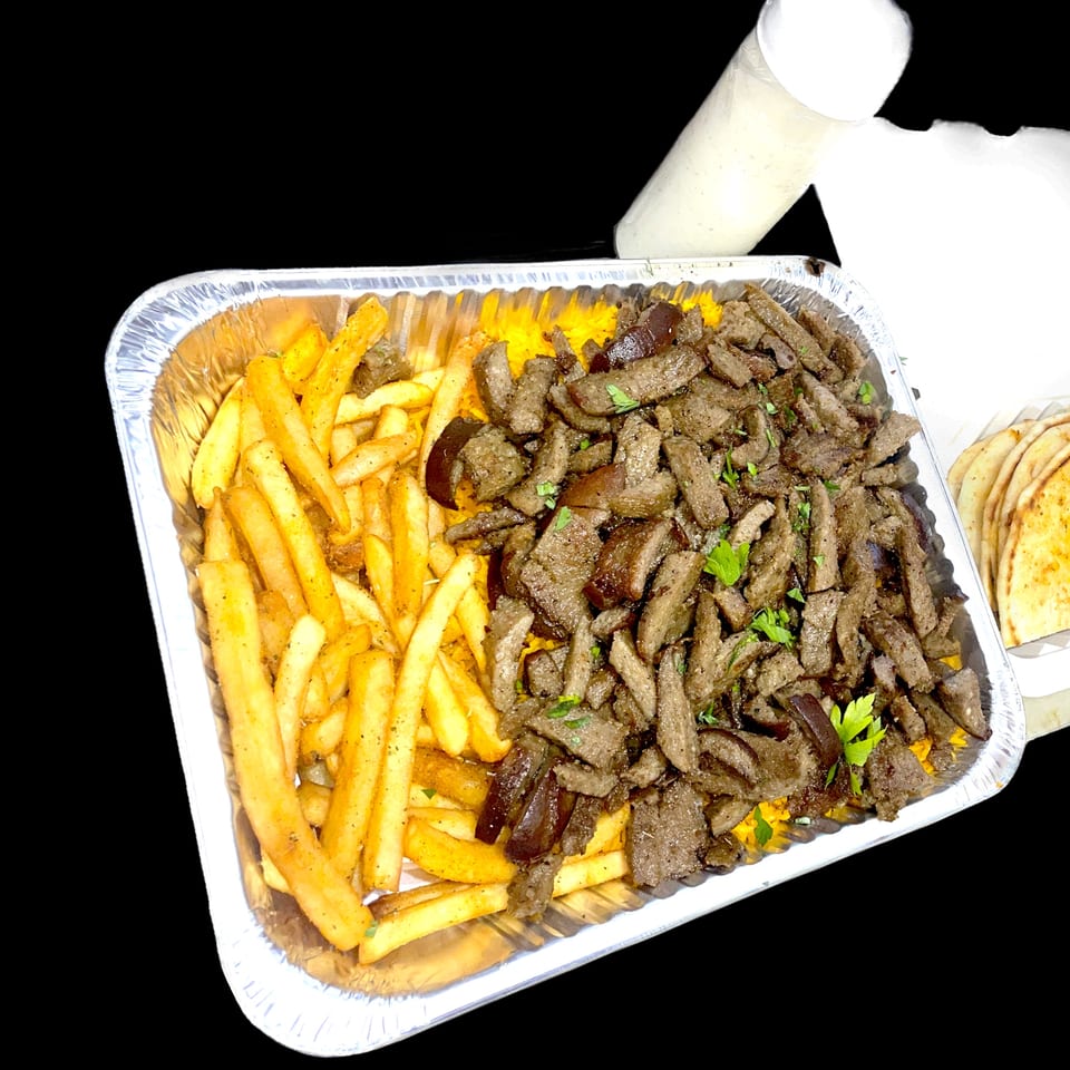 Gyro Flames' halal lamb and beef gyro meat with fries, rice, pita bread, and white sauce.